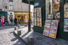 Posters and art prints displayed for sale outside a shop in Montmartre, Paris, France.