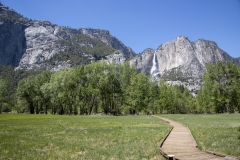 Spring landscape of Yosemite Valley with waterfalls, trees, and granite cliffs in California. The Meadow in Yosemite Valley