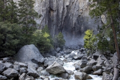 Spring landscape of Yosemite Valley with waterfalls, trees, and granite cliffs in California.