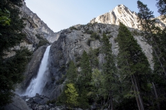 Spring landscape of Yosemite Valley with waterfalls, trees, and granite cliffs in California.