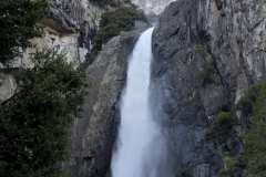 Spring landscape of Yosemite Valley with waterfalls, trees, and granite cliffs in California.