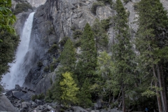 Spring landscape of Yosemite Valley with waterfalls, trees, and granite cliffs in California.