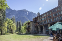 The Ahwahnee Hotel in Yosemite Valley surrounded by trees and mountains in the Sierra Nevada.