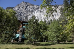 The Ahwahnee Hotel in Yosemite Valley surrounded by trees and mountains in the Sierra Nevada.