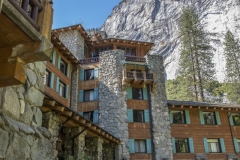 The Ahwahnee Hotel in Yosemite Valley surrounded by trees and mountains in the Sierra Nevada.