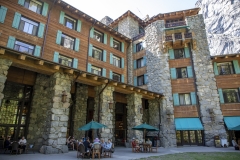 The Ahwahnee Hotel in Yosemite Valley surrounded by trees and mountains in the Sierra Nevada.