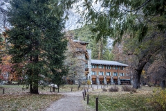 The Ahwahnee Hotel in Yosemite Valley surrounded by trees and mountains in the Sierra Nevada.