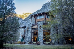 The Ahwahnee Hotel in Yosemite Valley surrounded by trees and mountains in the Sierra Nevada.