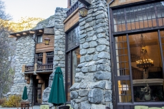 The Ahwahnee Hotel in Yosemite Valley surrounded by trees and mountains in the Sierra Nevada.