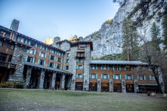The Ahwahnee Hotel in Yosemite Valley surrounded by trees and mountains in the Sierra Nevada.