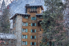 The Ahwahnee Hotel in Yosemite Valley surrounded by trees and mountains in the Sierra Nevada.